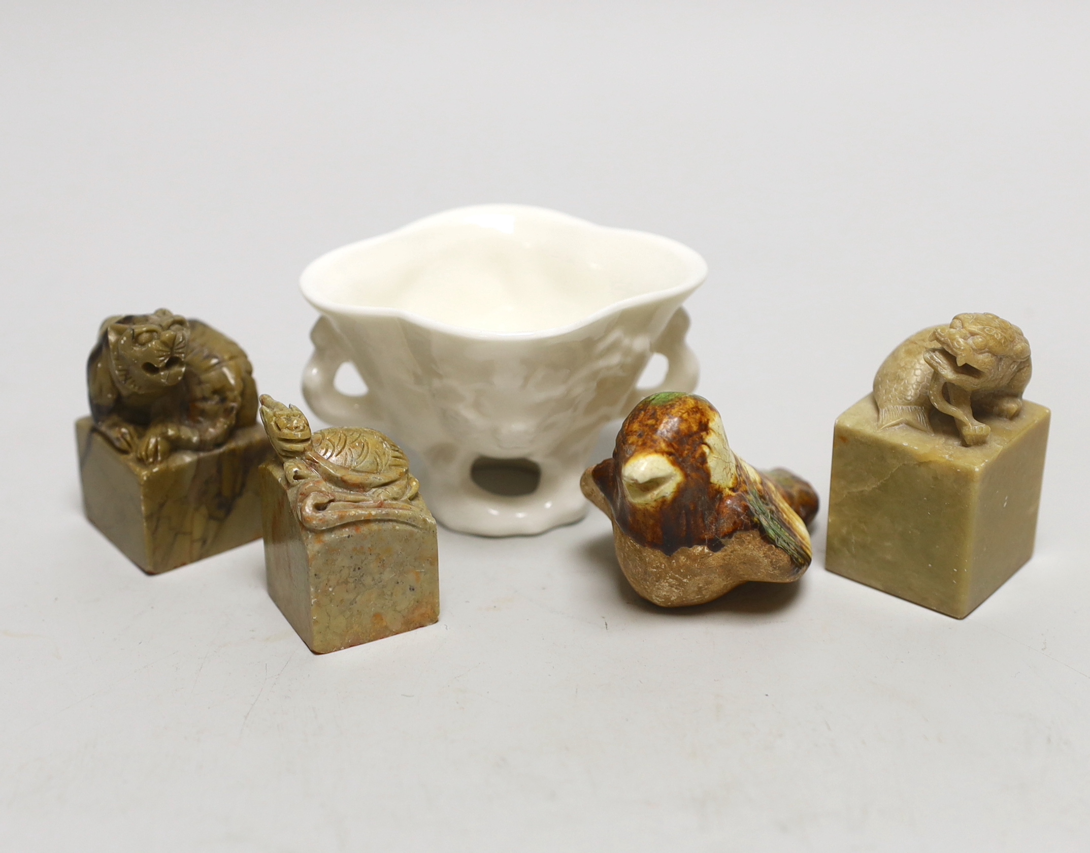 Three Chinese soapstone seals, a pottery bird and a blanc de chine pot